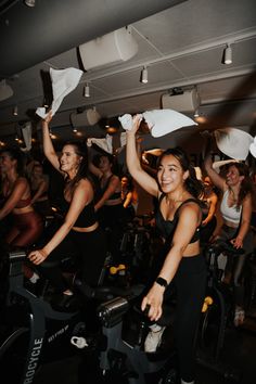 some people are riding stationary bikes in a gym with paper towels on their heads and arms