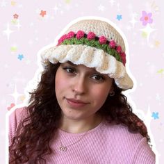 a woman wearing a crocheted hat with flowers on it's brim