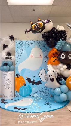 halloween balloons and decorations on display in an office cubicle with blue walls, wood flooring and white ceiling