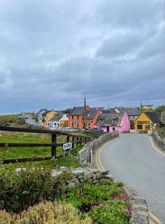 the road is lined with colorful houses on both sides