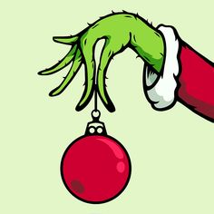 a hand holding a red ornament hanging from it's end with green hands