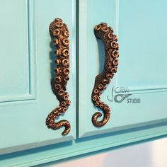 an octopus shaped door handle on a blue cabinet