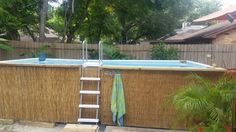 an above ground swimming pool with ladder to the side