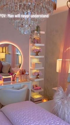 a bedroom decorated in pink and white with a chandelier hanging from the ceiling