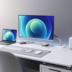 two computers are sitting on a desk with an apple monitor and keyboard in front of them