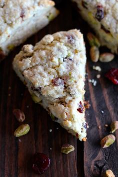 a close up of some food on a wooden table with cranberries and pistachios