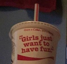 a cup with a straw in it that says girls just want to have fun on the side