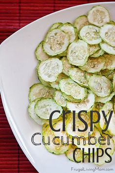 sliced cucumber chips on a white plate with red place mat in the background