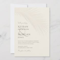 an elegant wedding card with palm leaves on the front and bottom, in neutral tones