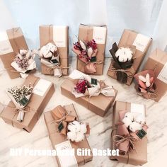 many wrapped presents are sitting on the table with cotton flowers in them and tied together