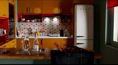 a kitchen filled with lots of appliances and counter top next to a refrigerator freezer