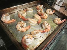 some shrimp are cooking in the oven on a sheet lined baking pan, and it's ready to be cooked