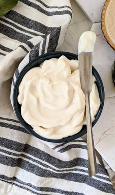 a bowl filled with cream sitting on top of a table