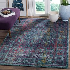 a living room with a purple chair and rug