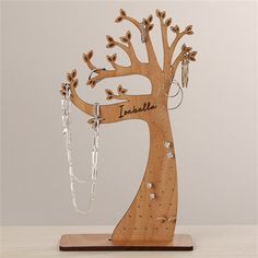 a wooden tree with earrings hanging from it's branches and the name danielle on it