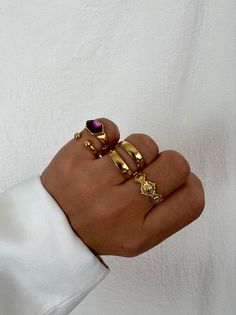 Introducing our exquisite handmade Gold rings! Our four stunning Stacking Rings are the ultimate accessory to add elegance and luxury to any outfit. The set includes a regal purple enamel stone ring and a chic open ring with two stunning beads. You'll also love our unique interconnected ring and smaller Boho-inspired ring, making for an irresistible combination. Check out the second photo to easily order the rings by number. Elevate your style with our handmade Gold rings, exclusively available Gold Rings Layered, Elegant Stackable Metal Rings, Gold Stackable Gemstone Open Rings, Gold Gemstone Stackable Open Rings, Gold Stackable Open Rings With Gemstones, Elegant Gold Rings With Unique Variations, Handmade Gold Oval Stackable Rings, Elegant Open Ring Jewelry With Unique Variations, Elegant Gold Amethyst Ring As Gift