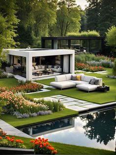 an outdoor living area with grass and flowers in the foreground, surrounded by water