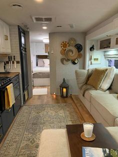 a living room filled with furniture next to a stove top oven and refrigerator freezer