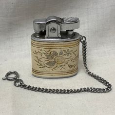 a lighter with a chain attached to it