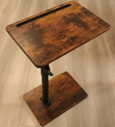 a small wooden table with metal legs and a square shaped tabletop on the top