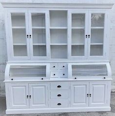 an old white china cabinet with glass doors and drawers on the bottom, in good condition