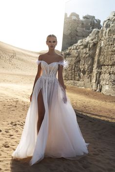 a woman in a white dress on the beach