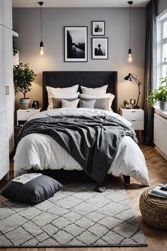 a bedroom with gray walls and white bedding, two framed pictures on the wall