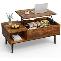 a coffee table with an open drawer underneath it and a laptop on the top shelf