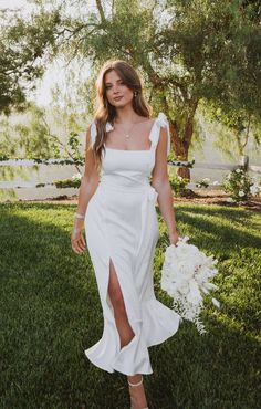 a woman in a white dress holding a bouquet