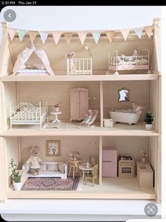 a doll house with furniture and accessories on display