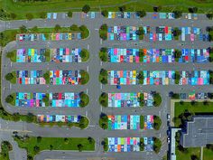 an aerial view of a parking lot with many cars parked in it