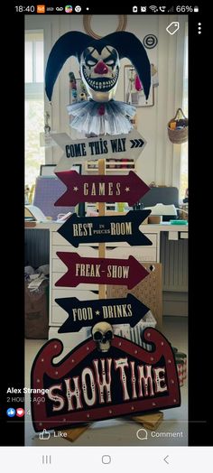 a wooden sign that says show time with clowns on it and arrows pointing in different directions