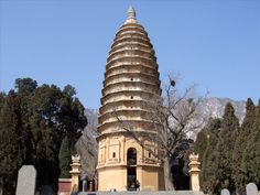 a very tall tower sitting in the middle of a cemetery