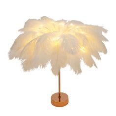 A beautiful table lamp can make life poetic and romantic. Our feather table lamp is like a lyrical poem. It brings an extraordinary artistic flavor to your home space with its unique design. The light shines through the gaps of the feather, shedding a soft and layered halo, creating a cozy, dreamy atmosphere, as if bringing moonlight and starlight into the room, allowing you to enjoy peace and tranquility. Choose it to light up your every beautiful moment. | Mercer41 Lahela Feather Table Lamp Be Art Deco Feather Light, Featger Lamp, White Feather Lamps, Festher Lamp, Feather Hanging Lamp, White Feather Floor Lamp, Flamingo Feather Lamp, Lyrical Poem, Lamp Feather