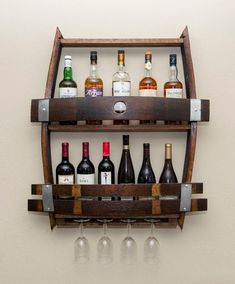 a wooden wine rack with bottles and glasses on it's sides, hanging from the wall