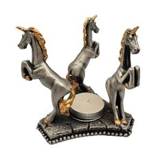 a silver and gold horse figurine sitting on top of a record player