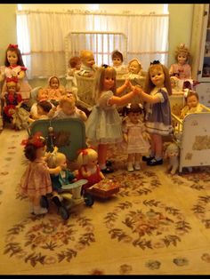 a group of dolls that are sitting on the floor