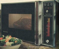 there is a bowl of salad in front of a microwave