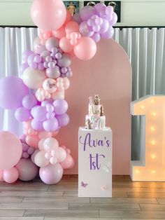 there is a birthday cake and balloons on the table