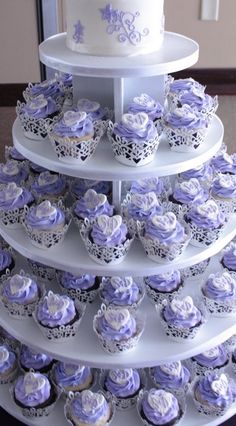 a three tiered cake and cupcake display