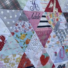 a close up of a quilt with many different designs on it and the words i love you