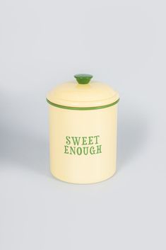 a yellow and green canister with the words sweet enough written on it's lid