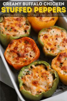 baked stuffed peppers in a baking dish with text overlay that reads creamy buffalo chicken stuffed peppers