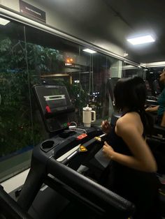 a woman running on a treadmill in a gym