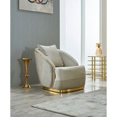 a living room with a chair, rug and table in the corner that has a painting on the wall behind it