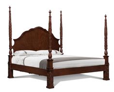 a wooden bed with four posts and white linen on the bottom sheet, in front of a white background