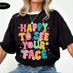 Happy To See Your Face Shirt, Teacher Shirts, First Day Of School Shirt Discover Our Latest Range Of Versatile And Stylish T-Shirts (Gildan 5000), Where Style Harmonizes With Unparalleled Comfort! Featuring Sizes From S To 3xl And A Vibrant Spectrum Of Colors Such As Black, White, Sand, Green, Sport Grey, Red, Navy, And More, There's A Choice To Cater To Every Taste. Crafted With Precision Using Top-Notch Materials, Our T-Shirts Offer A Luxurious Sensation And An Impeccable Fit That Endures Thro Trendy Black Shirt With Funny Text, Black Slogan Shirt For Spring, Black Top With Funny Text For Spring, Black Spring Top With Funny Text, Spring Black Top With Funny Text, Black T-shirt With Funny Text For Spring, Fun Black Shirt With Slogan, Fun Black Shirt With Letter Print, Black Top With Funny Print For Everyday