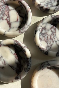 four marbled dishes sitting on top of each other