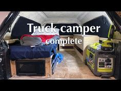 the inside of a truck camper with its bed pulled up to it's side