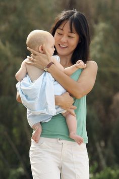 a woman holding a baby in her arms